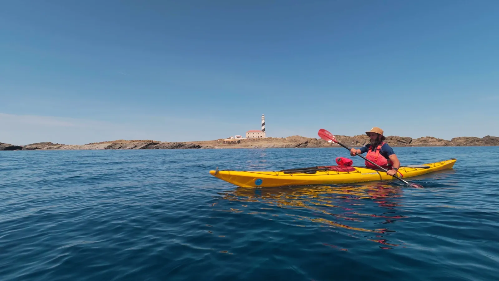 Kayakiste en kayak de mer près de la côte du parc naturel et du phare de Favàritx